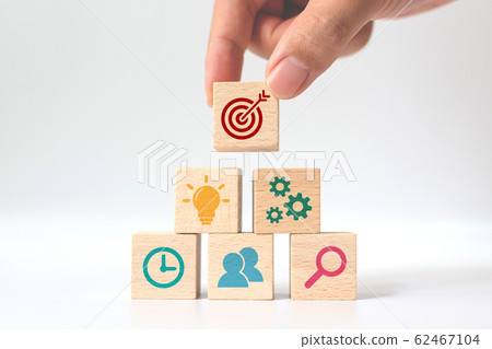 Concept of business strategy and action plan. Hand putting wooden cube block stacking with icon 62467104