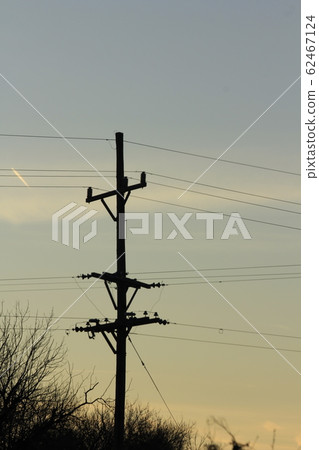 Kansas colorful Sunset with clouds and tree's and Power Line silhouette. Kansas colorful Sunset with clouds and tree's and Power Line silhouette. 62467124