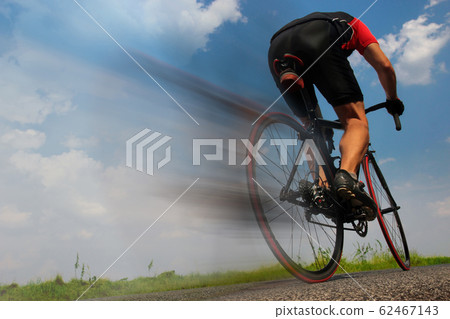 cyclist riding fast on the asphalt road cyclist riding fast on the asphalt road 62467143