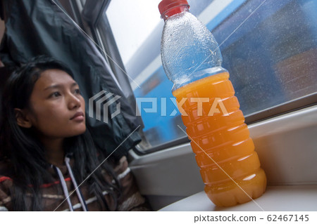 young woman riding by railway and look out of the 62467145