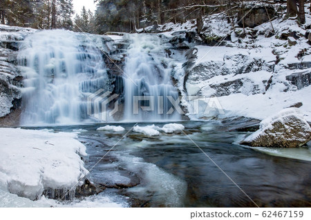 Waterfall in snowy forest. Winter Mumlava, Czechia Waterfall in snowy forest. Winter Mumlava, Czechia 62467159