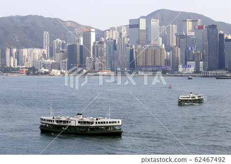 Star ferry sailing through Victoria Bay in Hong Kong 62467492