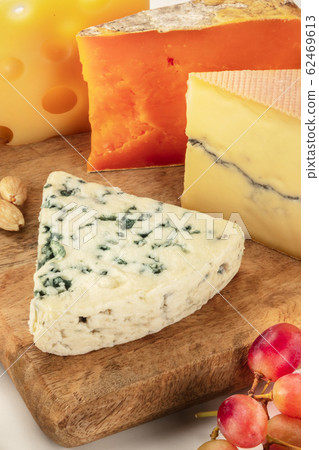 Cheese platter. Blue cheese, goat cheese etc, a close-up on a wooden board Cheese platter. Blue cheese, goat cheese etc, a close-up on a wooden board 62469613