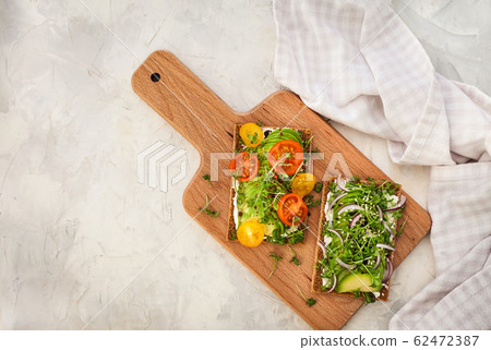 Avocado rye toasts with green herbs, onion and Avocado rye toasts with green herbs, onion and 62472387