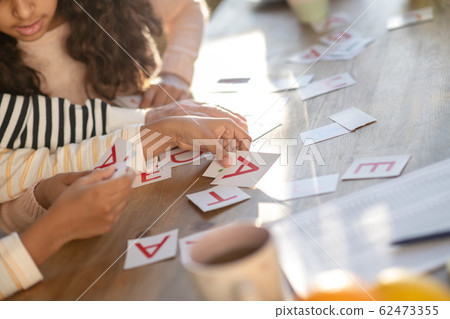 Close up picture of human hands putting the cards on the table 62473355