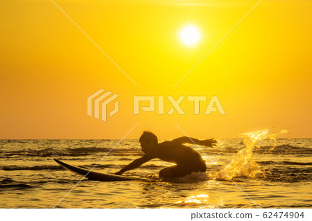 Surfing at Sunset. Outdoor Active Lifestyle. Summer water sport. 62474904