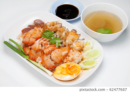 Barbecued red pork and crispy pork in sauce with rice, Chinese style roasted pork. Barbecued red pork and crispy pork in sauce with rice, Chinese style roasted pork. 62477687