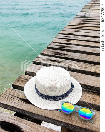 vacation on summer time at the beach concept. beach accessories on wooden bridge. summer background. vacation on summer time at the beach concept. beach accessories on wooden bridge. summer background. 62477909