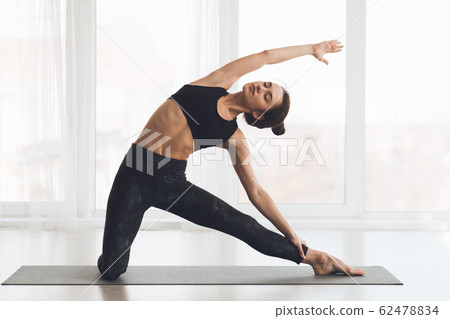Relaxed girl streching arms and legs at home 62478834