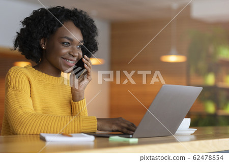 Cheerful black lady with laptop looking for job 62478854