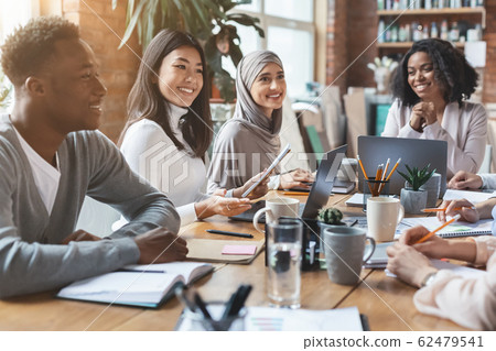 Close up of young multiracial team having meeting in office Close up of young multiracial team having meeting in office 62479541