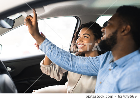 Black Couple Choosing New Car In Dealership Center Black Couple Choosing New Car In Dealership Center 62479669