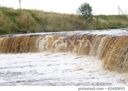 Waterfall with a huge current, mountain waterfall. Waterfall with a huge current, mountain waterfall. 62480693