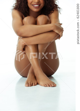 Slim tanned woman's body isolated on white studio background Slim tanned woman's body isolated on white studio background 62481800