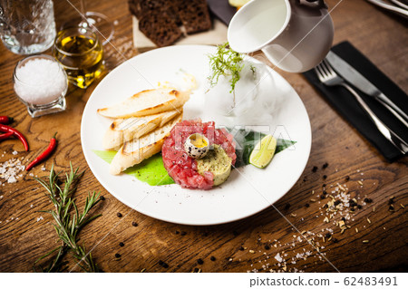 Tuna tartare served on a plate in restaurant 62483491