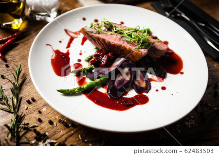 Duck breast served on a plate in restaurant Duck breast served on a plate in restaurant 62483503