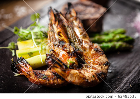 Tasting menu. Beef steak and grilled tiger prawns. Tasting menu. Beef steak and grilled tiger prawns. 62483535