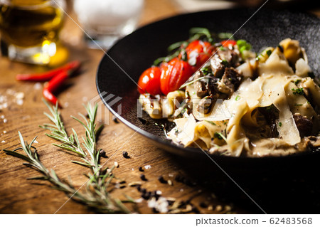 Black Angus Pasta served in a black bowl in restaurant 62483568
