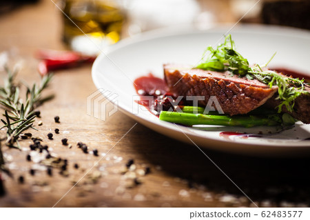 Duck breast served on a plate in restaurant 62483577