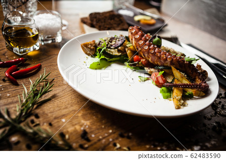 Octopus salad served on a plate in restaurant Octopus salad served on a plate in restaurant 62483590