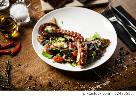Octopus salad served on a plate in restaurant Octopus salad served on a plate in restaurant 62483593