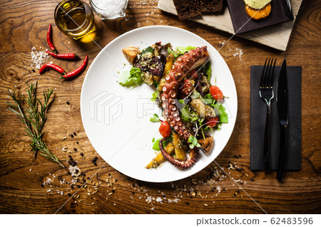 Octopus salad served on a plate in restaurant Octopus salad served on a plate in restaurant 62483596