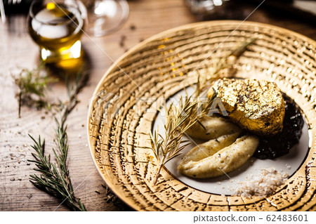 Black Angus tenderloin steak covered with 24 carat gold Black Angus tenderloin steak covered with 24 carat gold 62483601