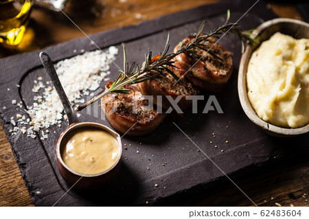 Pork tenderloin served on a board in restaurant Pork tenderloin served on a board in restaurant 62483604