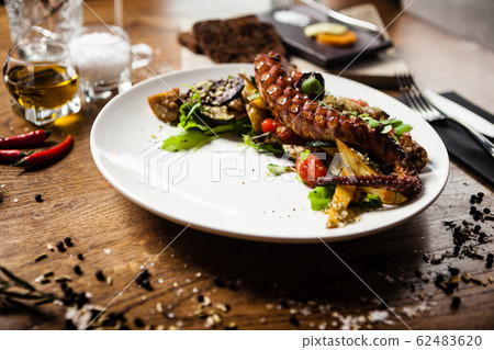 Octopus salad served on a plate in restaurant Octopus salad served on a plate in restaurant 62483620