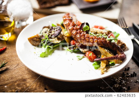 Octopus salad served on a plate in restaurant Octopus salad served on a plate in restaurant 62483635