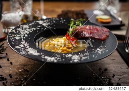 Clear Fish soup served in a bowl in restaurant Clear Fish soup served in a bowl in restaurant 62483637