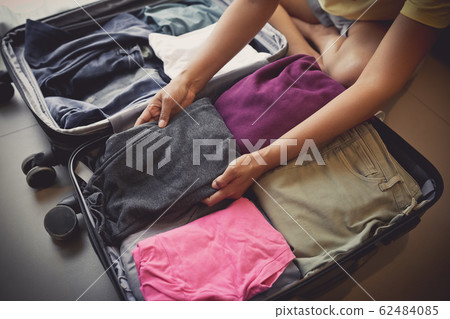 woman packing bag for traveling 62484085