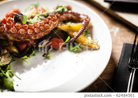 Octopus salad served on a plate in restaurant Octopus salad served on a plate in restaurant 62484301