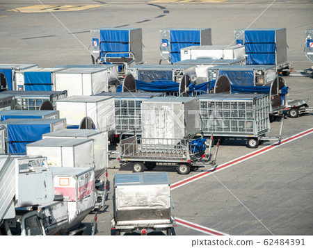 Image of lots of luggage and cargo delivery carts in airport ground service parking Image of lots of luggage and cargo delivery carts in airport ground service parking 62484391