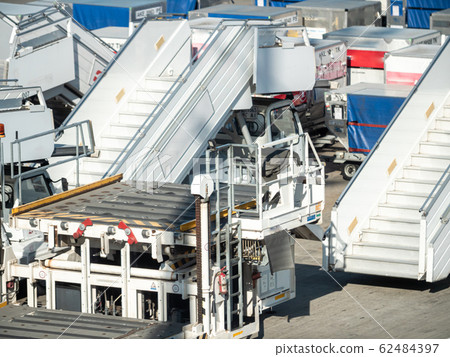 Image of empty boarding ladders and stairways in airport waiting for airplane arrival Image of empty boarding ladders and stairways in airport waiting for airplane arrival 62484397