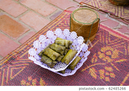 Alms wrapped in glutinous rice and banana leaves 62485266