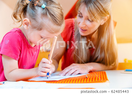 Children and play school teacher drawing together 62485443