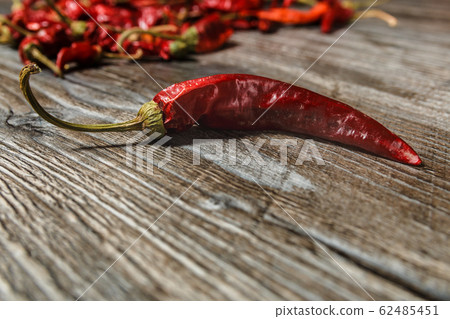 one dried red hot chilli peppers on old wooden table one dried red hot chilli peppers on old wooden table 62485451