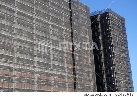 A condominium covered with a sheet due to exterior wall repair work A condominium covered with a sheet due to exterior wall repair work 62485618