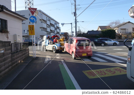 Vehicle towed by a tow truck 62486012