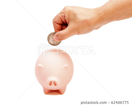 Male hand putting coin into piggy bank isolated on Male hand putting coin into piggy bank isolated on 62486775