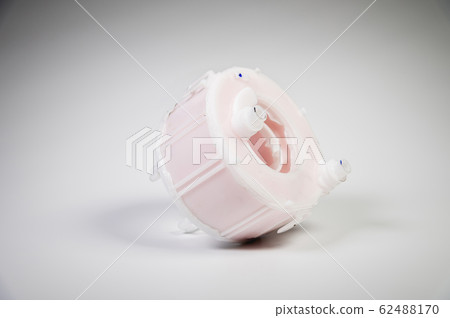 New spare part. Replaceable white plastic inner fuel filter on a gray gradient background 62488170