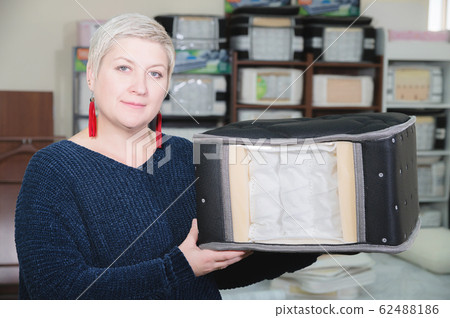 An example sampler is the material of a mattress in the hands of an attractive woman. Portrait of a pretty short-haired adult woman in a furniture store. An example sampler is the material of a mattress in the hands of an attractive woman. Portrait of a pretty short-haired adult woman in a furniture store. 62488186