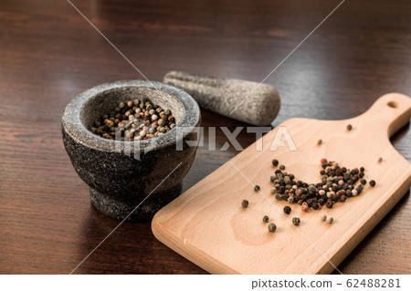 peppercorns with granite mortar peppercorns with granite mortar 62488281