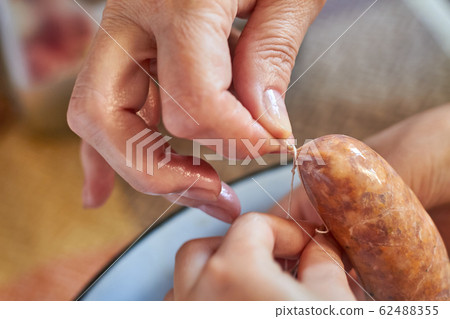 A grandma and a girl manually makes homemade 62488355