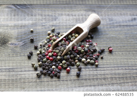 peppercorns on wooden spoon peppercorns on wooden spoon 62488535