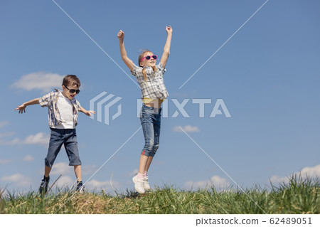 Brother and sister playing on the field Brother and sister playing on the field 62489051