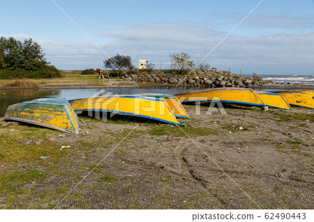 yellow fishing boats lie on the sand by the river, yellow fishing boats lie on the sand by the river, 62490443