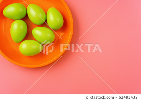 Close up of green Easter eggs in a bright plate on Close up of green Easter eggs in a bright plate on 62493432