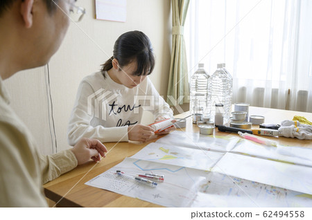 Family checking emergency supplies 62494558